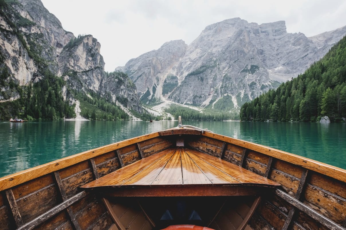 Train traveling beside a mountain lake