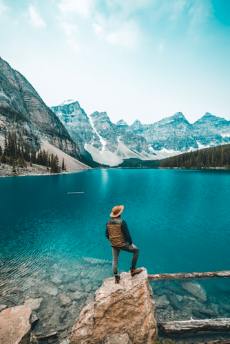 Traveler overlooking a turquoise lake